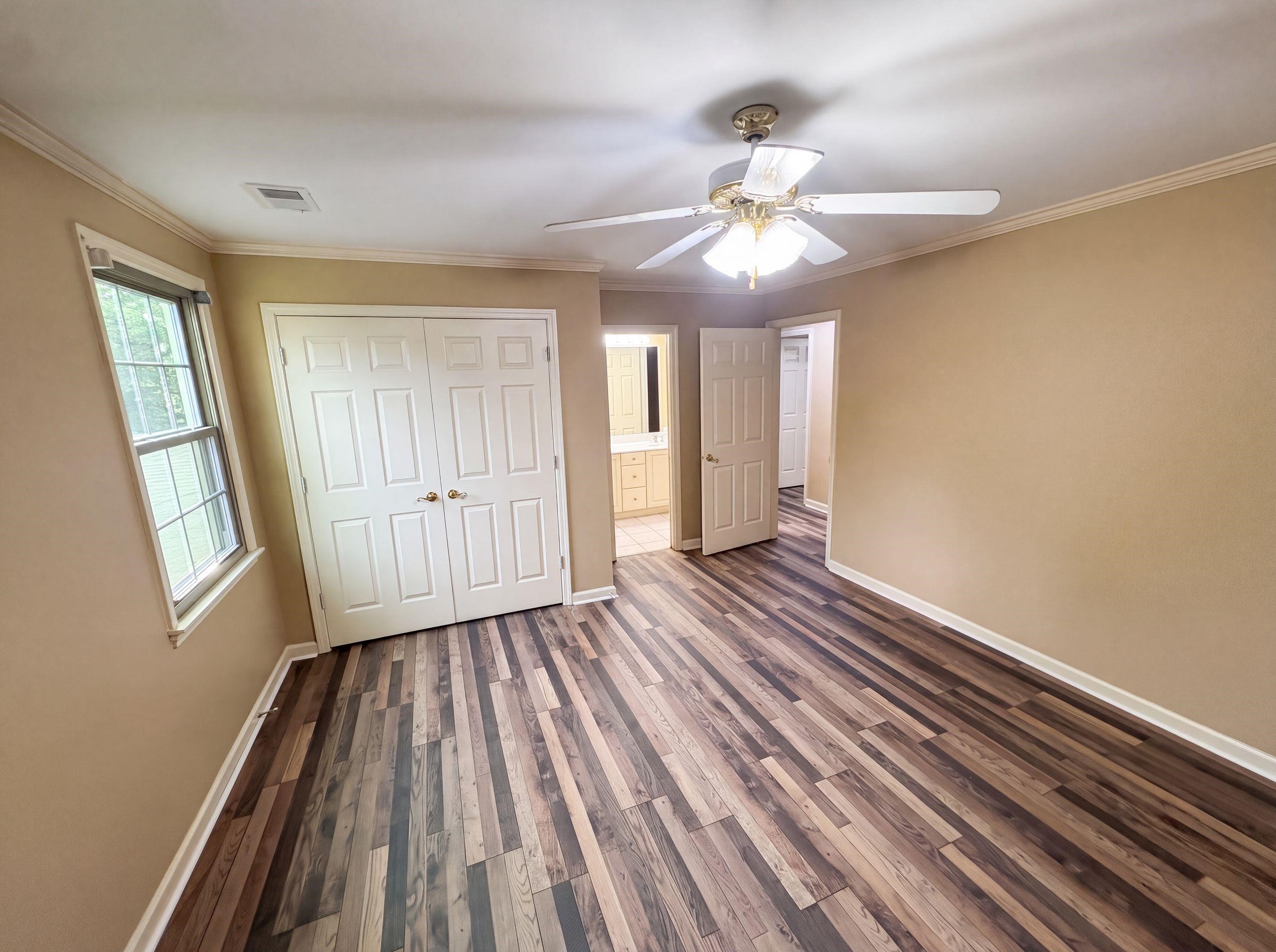 9424 Gotten Road Germantown, TN 38139 - Photo 16 of 27 Room featuring multi-tone wood-finish flooring, neutral wall paint, and white baseboards