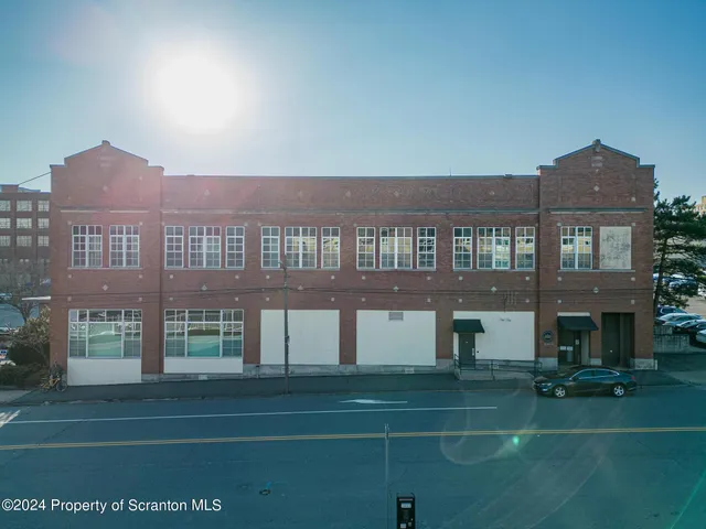 a front view of building with yard