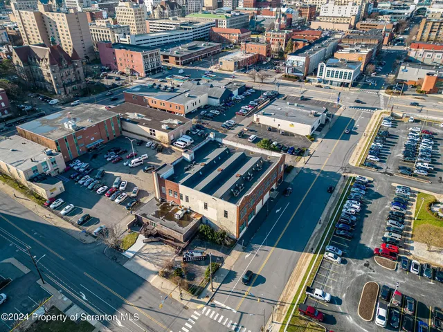 a kitchen with stainless steel appliances granite countertop a refrigerator a stove and a refrigerator