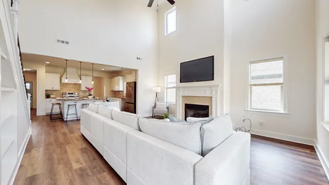 a bedroom with a bed couches chair and a window