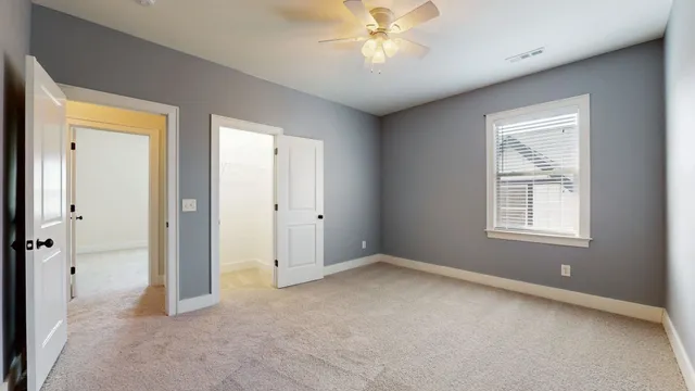 a front view of a house with a garden and deck