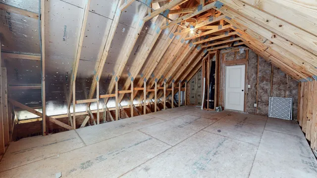 an aerial view of a house with swimming pool and lake view