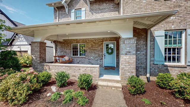an aerial view of residential house with outdoor space and trees all around