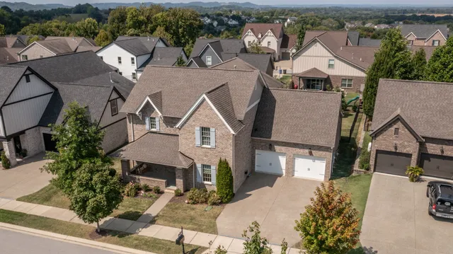 an aerial view of a house with a yard and lake view