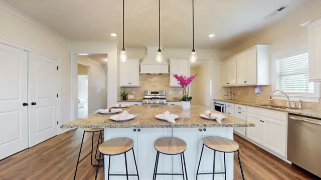 a kitchen with granite countertop a sink stove and cabinets