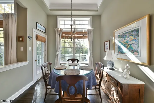 a dining room with furniture a chandelier and wooden floor