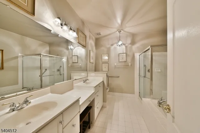 a spacious bathroom with a shower sink double and mirror