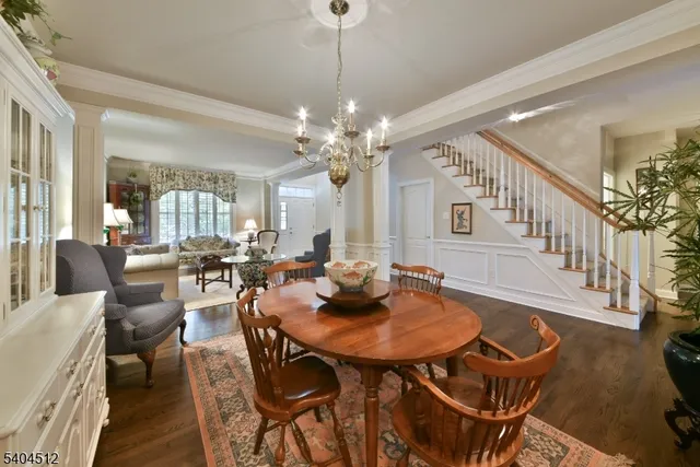 a view of a dining room with furniture and a chandelier