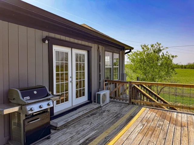 a view of balcony with wooden floor and seating space