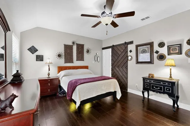 a bedroom with a bed dresser and a desk