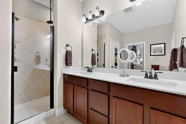 a bathroom with a double vanity sink and a mirror