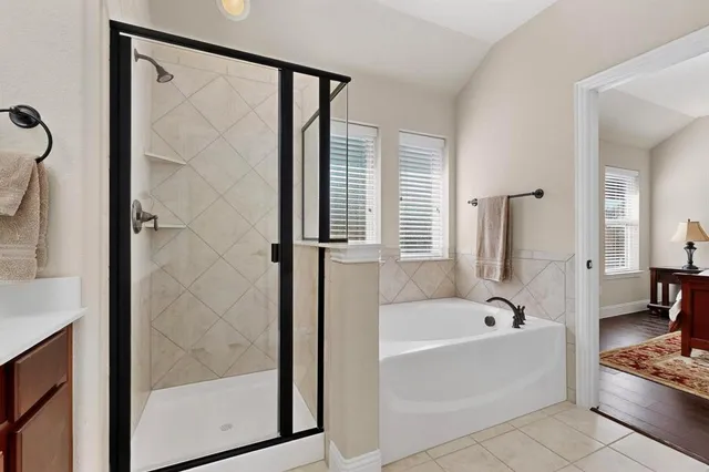 a bathroom with a bathtub and a shower
