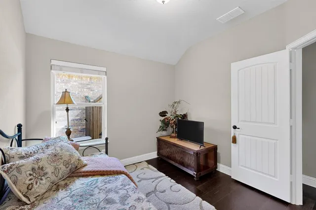 a bedroom with a bed and a dresser