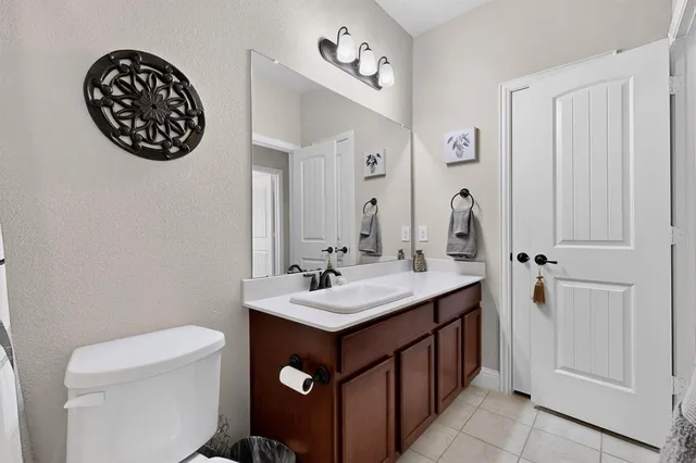 a bathroom with a sink a toilet and a mirror