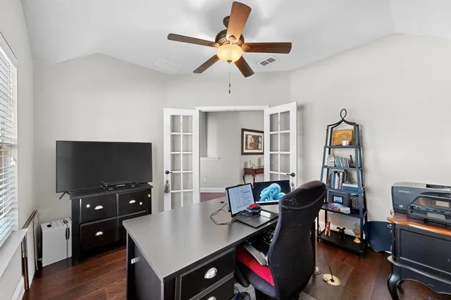 a view of a workspace with furniture and wooden floor