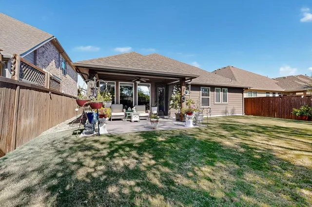 a view of a house with backyard and sitting area