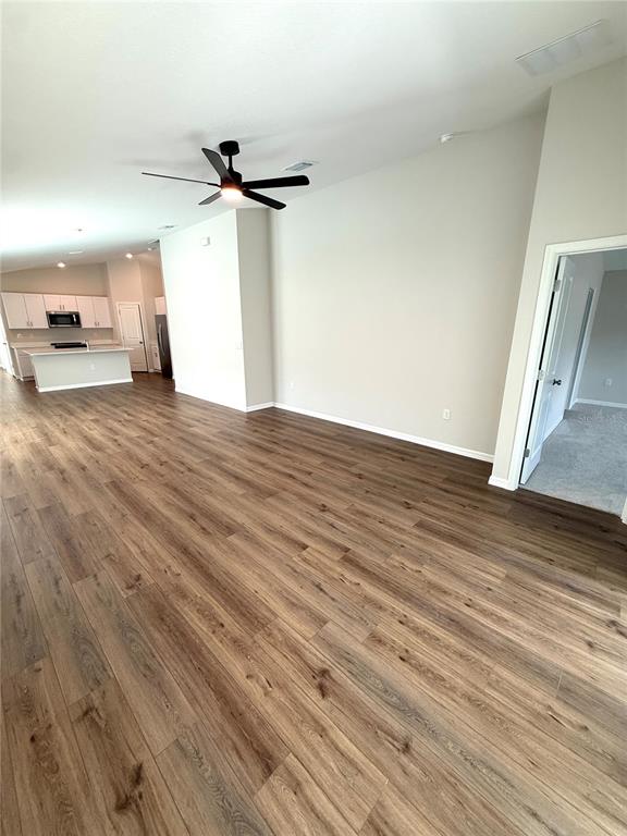 34706 Blossom Fall Path Dade City, FL 33525 - Photo 13 of 27 a view of empty room with wooden floor