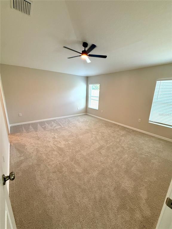 34706 Blossom Fall Path Dade City, FL 33525 - Photo 14 of 27 an empty room with windows and fan