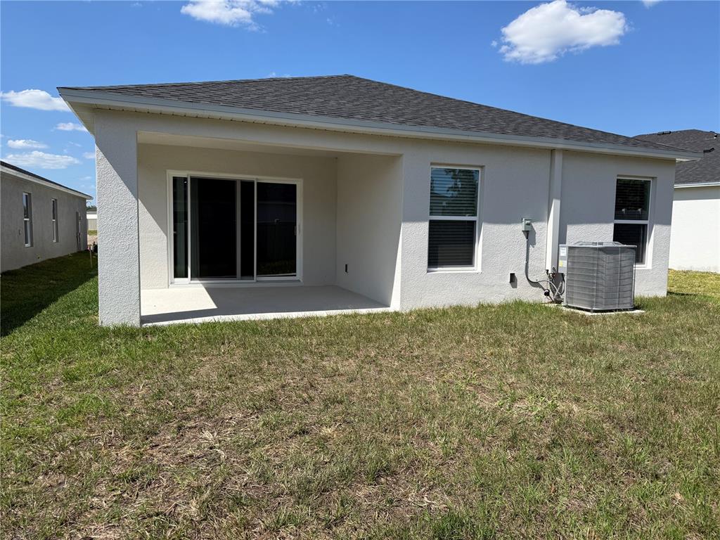 34706 Blossom Fall Path Dade City, FL 33525 - Photo 20 of 27 a view of a house with backyard and porch