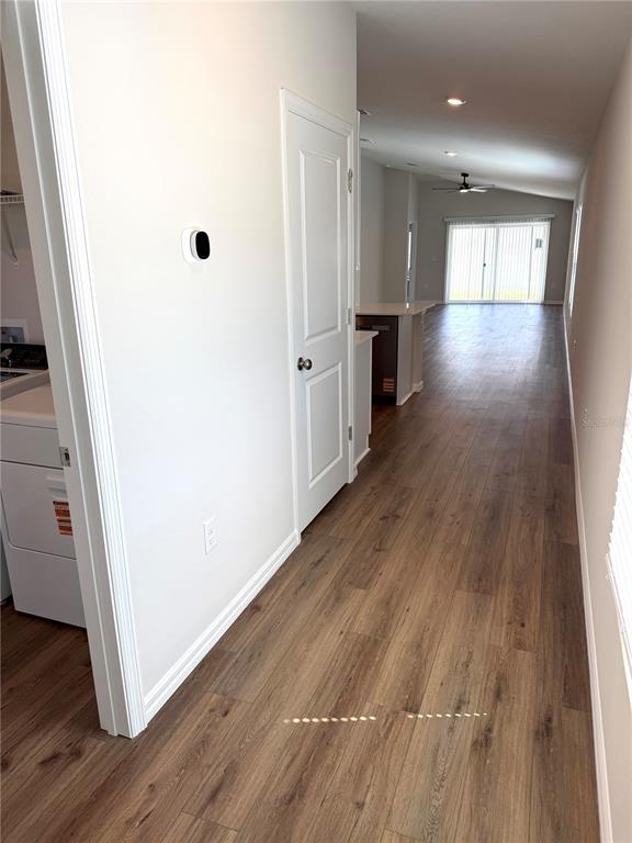 34706 Blossom Fall Path Dade City, FL 33525 - Photo 2 of 27 an empty room with wooden floor and windows