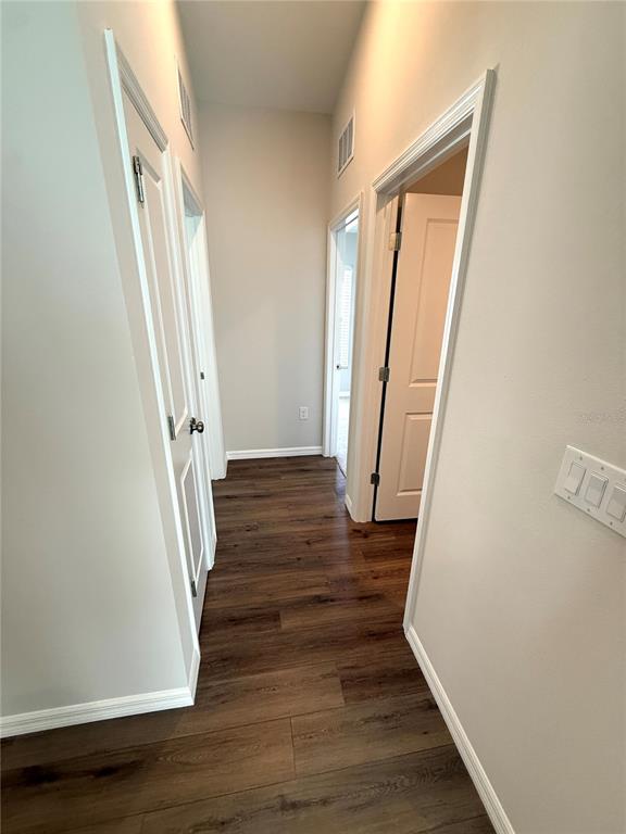 34706 Blossom Fall Path Dade City, FL 33525 - Photo 7 of 27 a view of a hallway with wooden floor and staircase