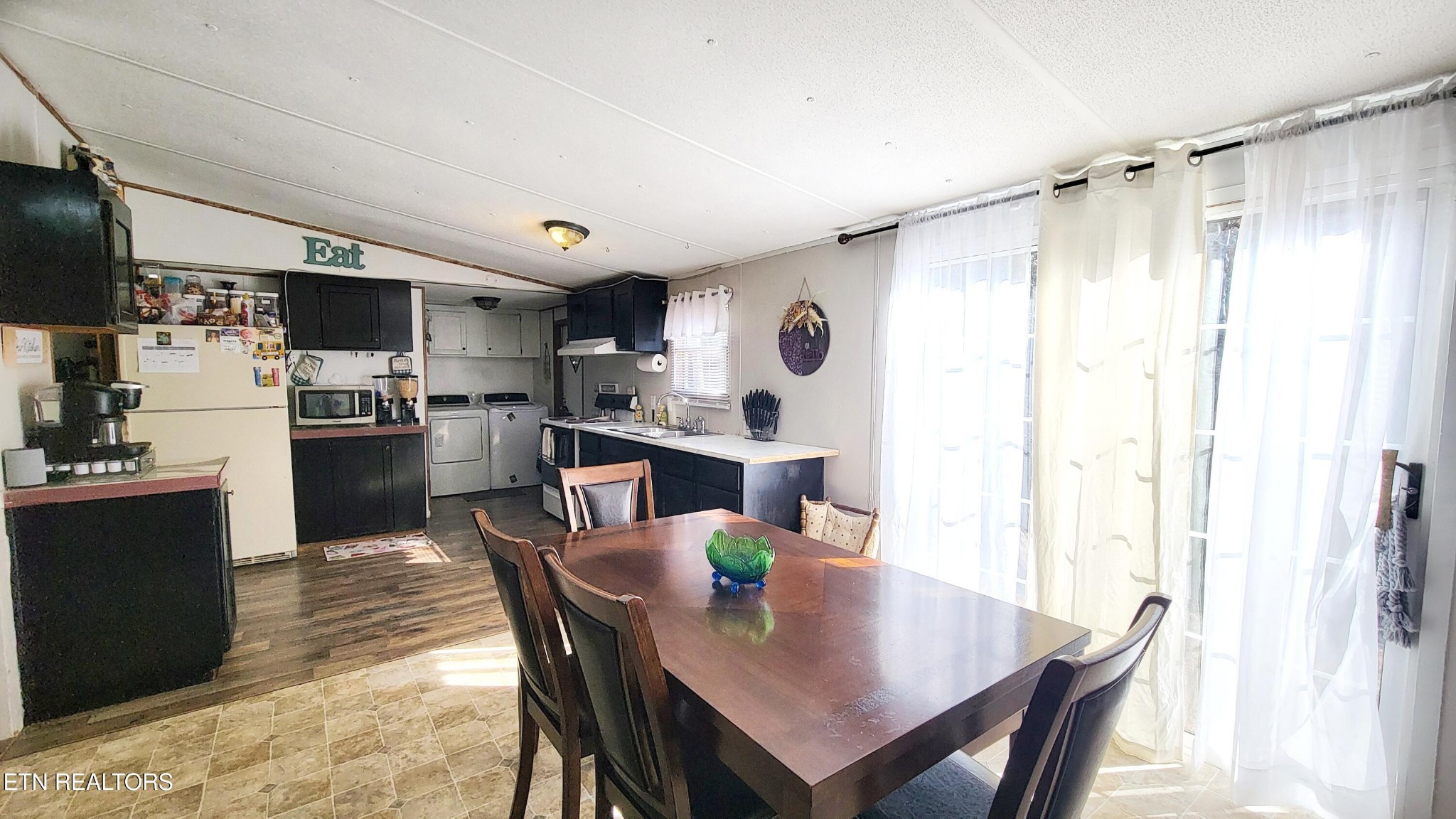 1290 Bluets Road Newport, TN 37821 - Photo 13 of 34 a kitchen with stainless steel appliances a dining table chairs and refrigerator