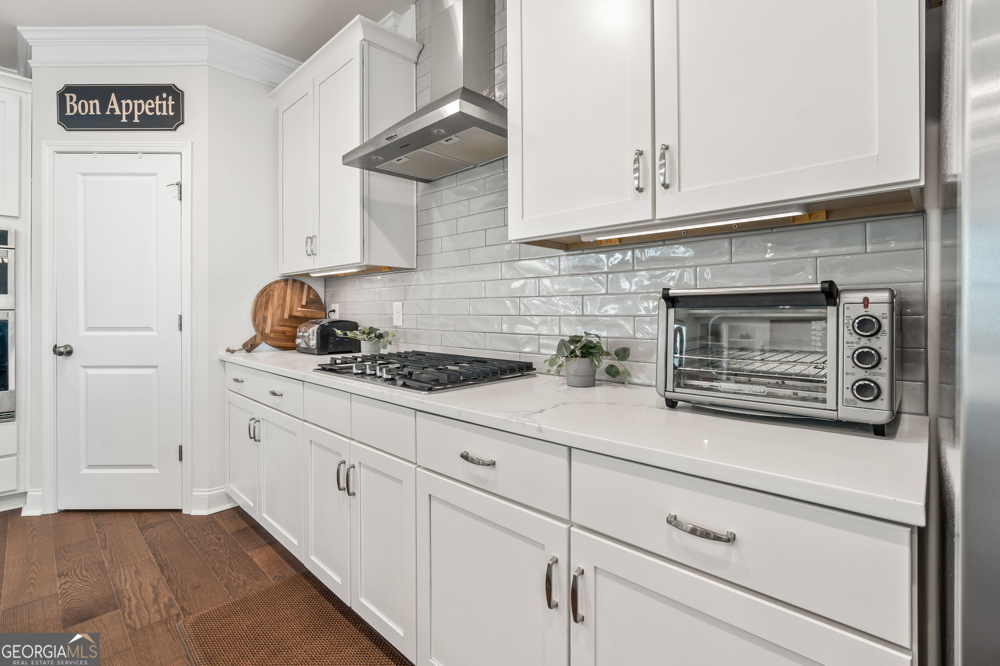 2884 Porches Lane Dacula, GA 30019 - Photo 11 of 41 a kitchen with white cabinets and a stove