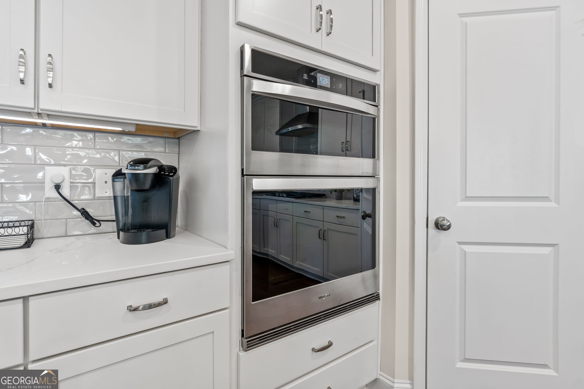 2884 Porches Lane Dacula, GA 30019 - Photo 12 of 41 a kitchen with a stove and white cabinets
