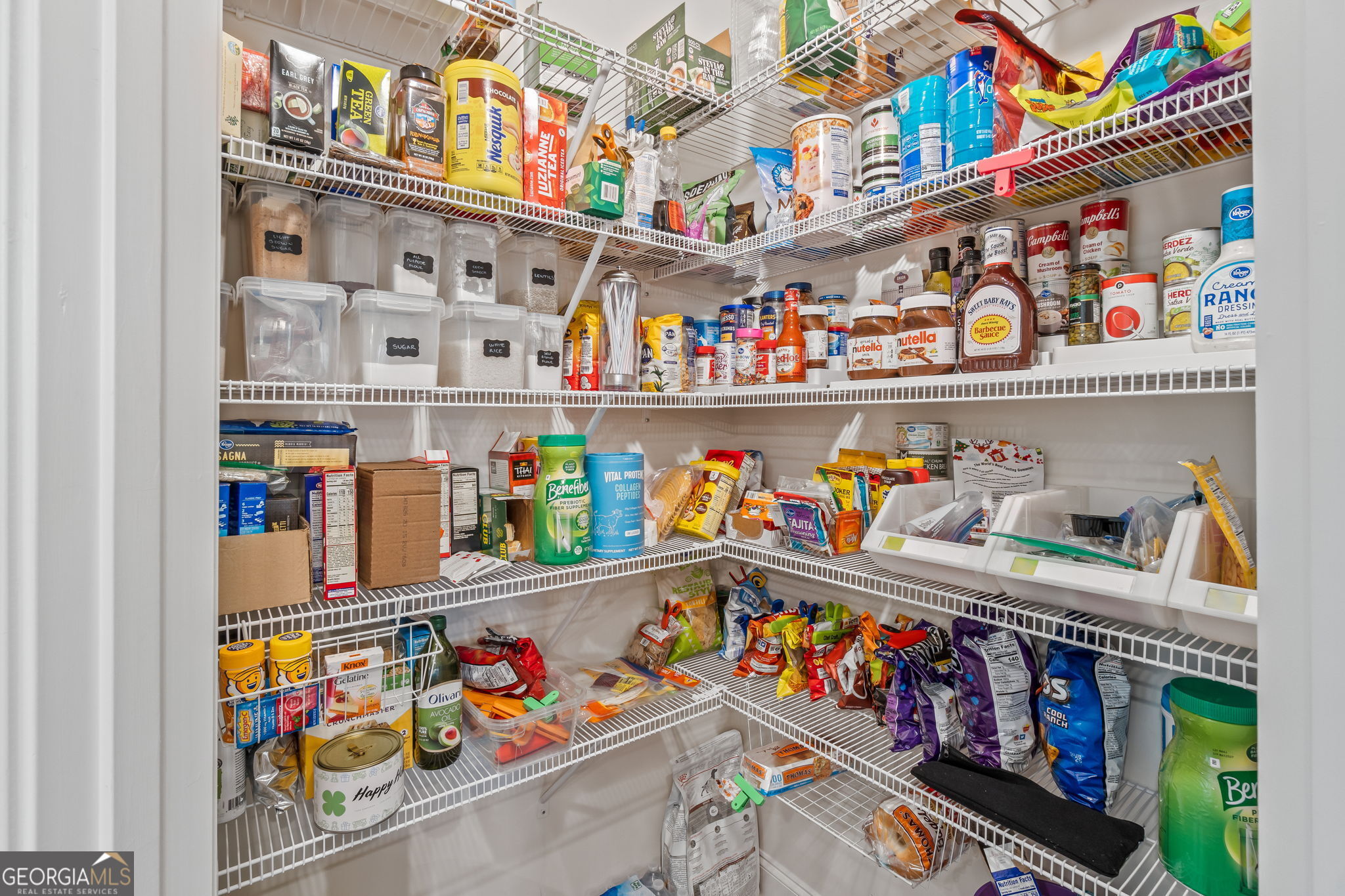 2884 Porches Lane Dacula, GA 30019 - Photo 13 of 41 a store room with lots of clutter and refrigerator