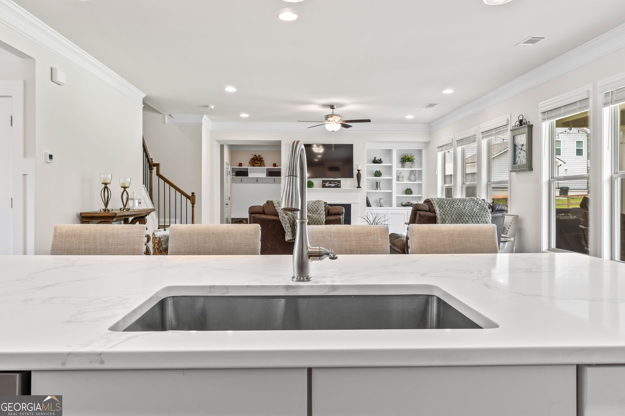 2884 Porches Lane Dacula, GA 30019 - Photo 14 of 41 a view with kitchen island sink and living room