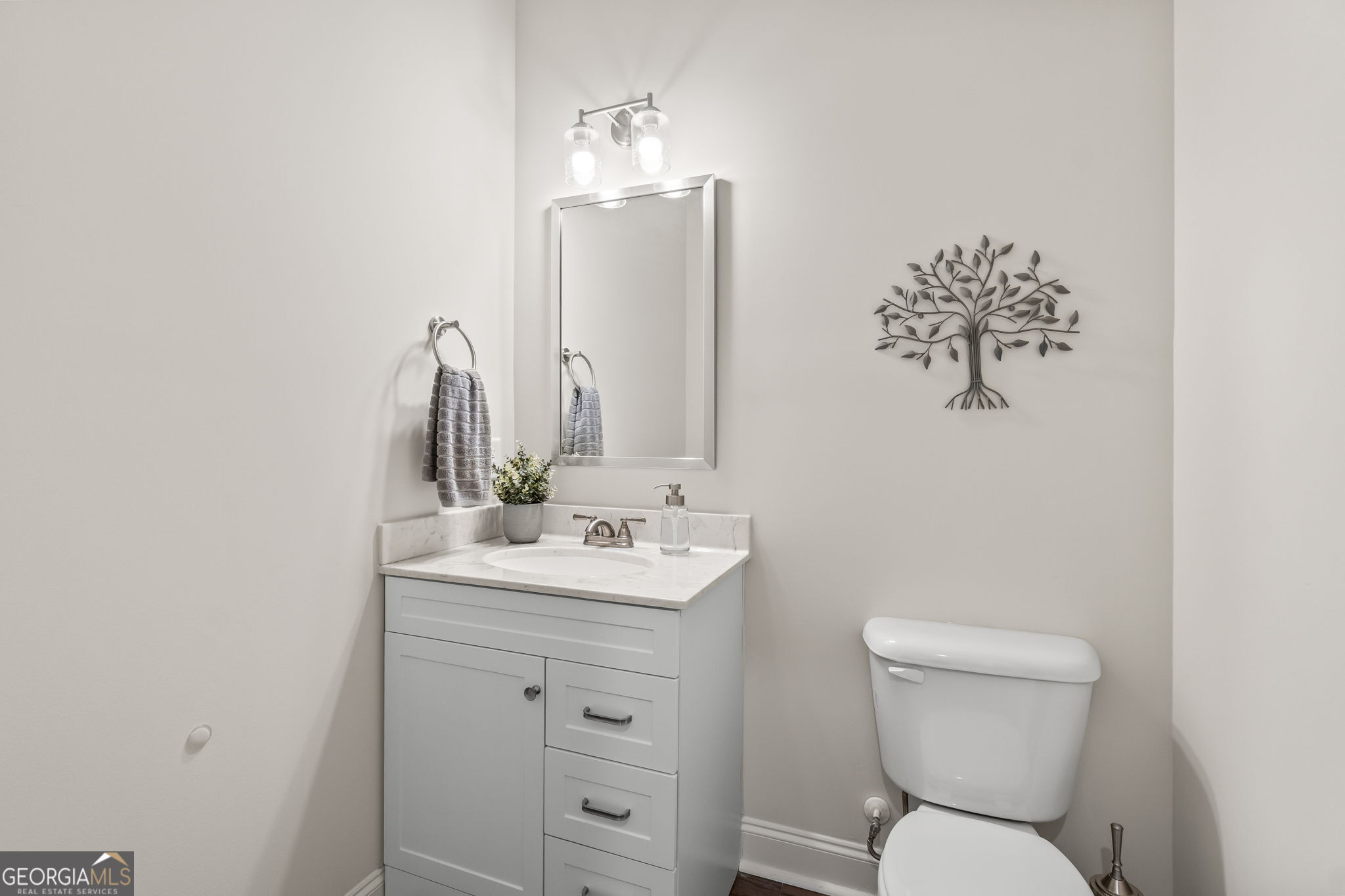 2884 Porches Lane Dacula, GA 30019 - Photo 15 of 41 a bathroom with a toilet sink and mirror