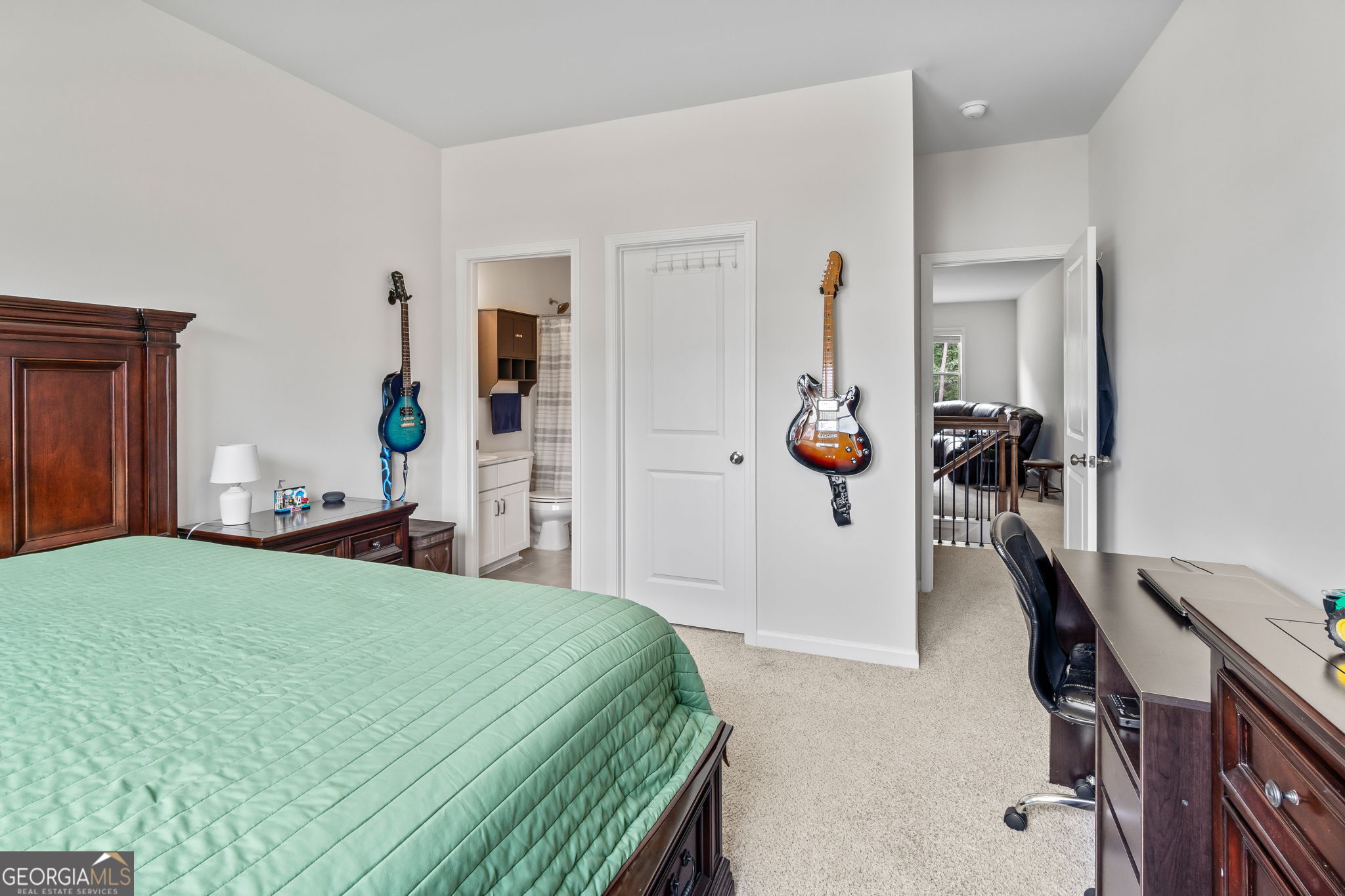 2884 Porches Lane Dacula, GA 30019 - Photo 24 of 41 a bedroom with a bed a mirror and gym equipment