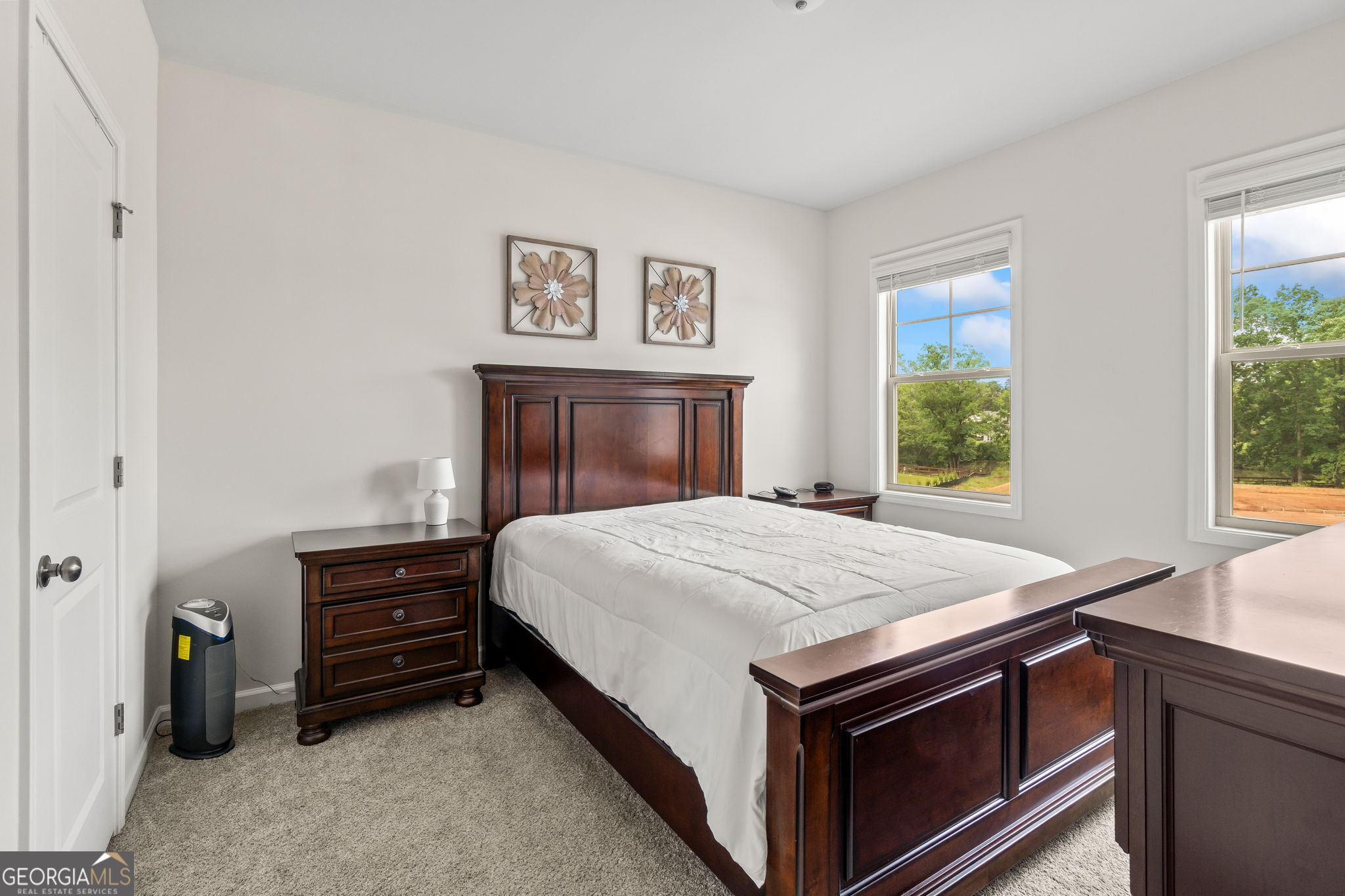 2884 Porches Lane Dacula, GA 30019 - Photo 27 of 41 a bed sitting in a bedroom next to a window
