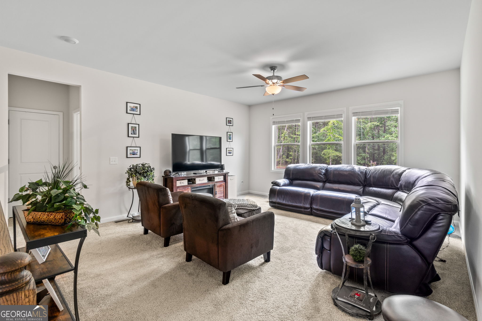 2884 Porches Lane Dacula, GA 30019 - Photo 30 of 41 a living room with furniture a large window and a flat screen tv