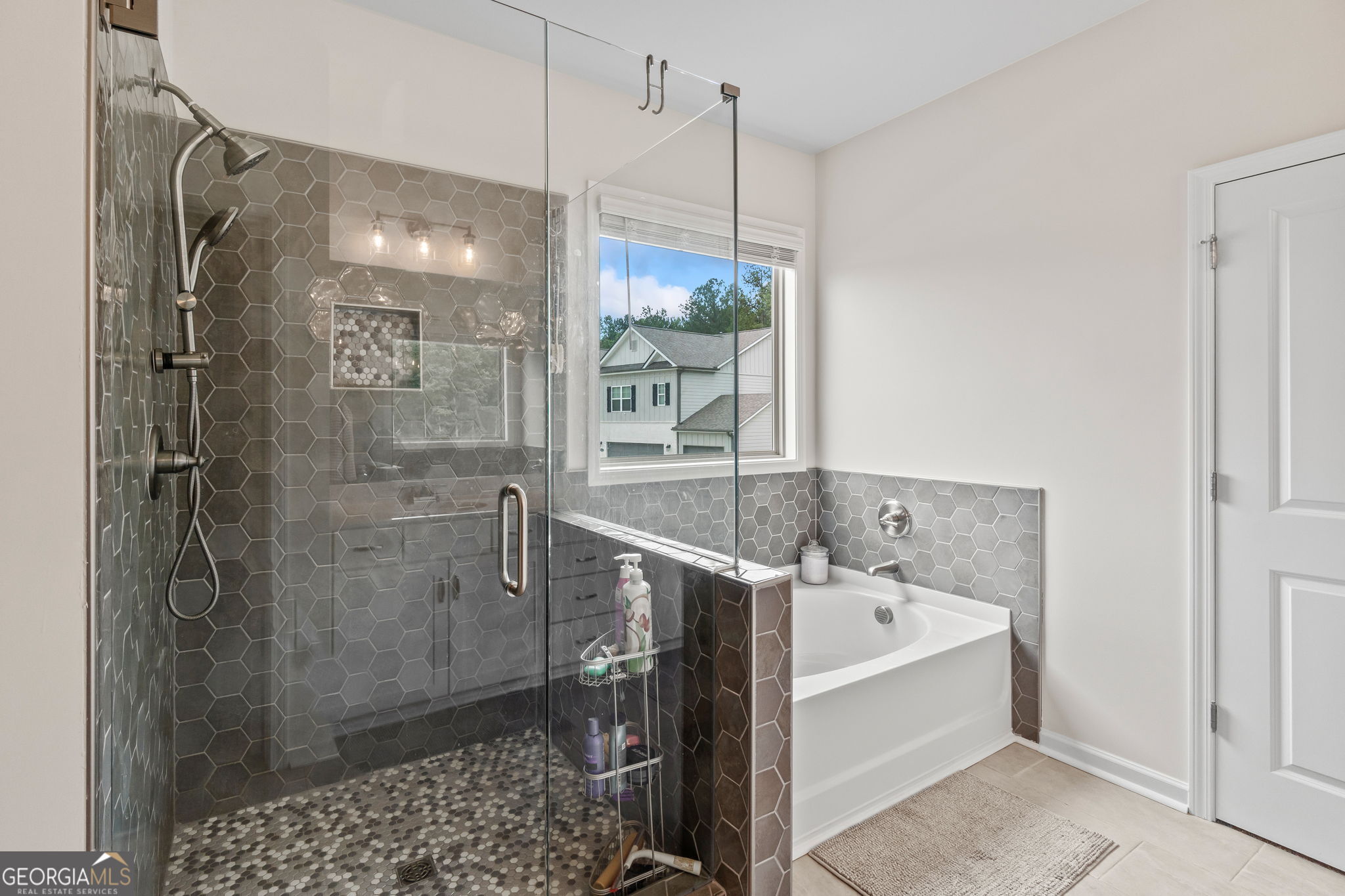 2884 Porches Lane Dacula, GA 30019 - Photo 34 of 41 a bathroom with a bathtub and a shower