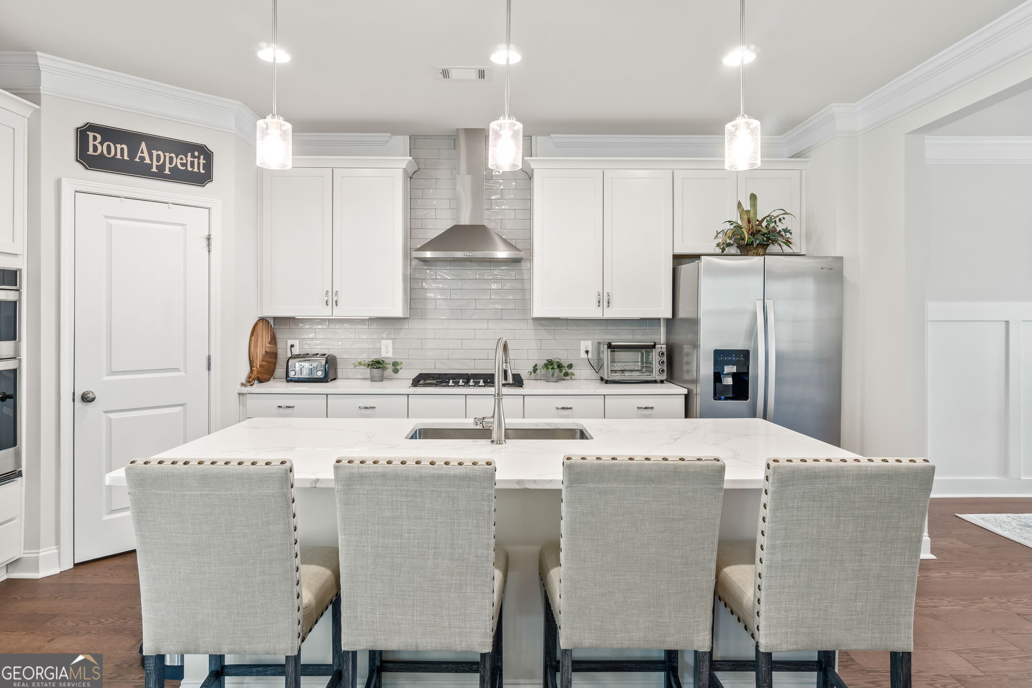 2884 Porches Lane Dacula, GA 30019 - Photo 9 of 41 a kitchen with stainless steel appliances kitchen island granite countertop a dining table and chairs