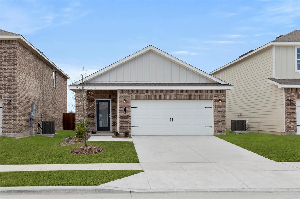 a front view of house with garage and green space