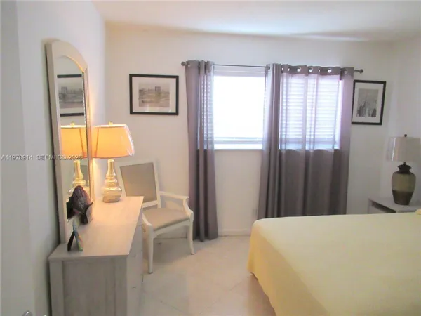 a bed room with a bed and a window