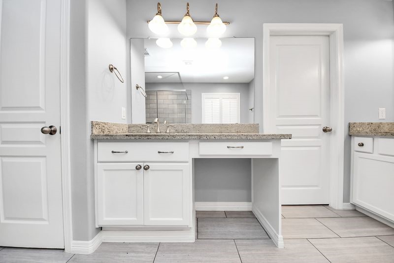 4222 Drake Street Houston, TX 77005 - Photo 20 of 28 a bathroom with a granite countertop sink and a mirror