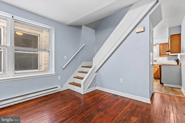 wooden floor in an empty room with a window and wooden floor