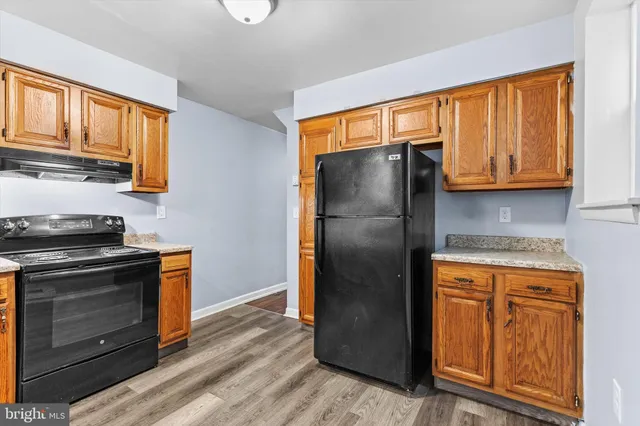 a kitchen with stainless steel appliances granite countertop a refrigerator stove and sink