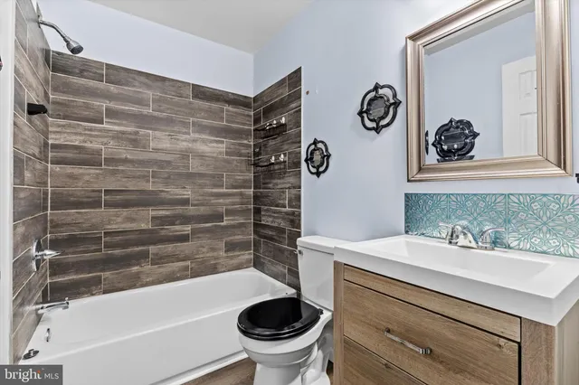 a bathroom with a sink a toilet and bathtub