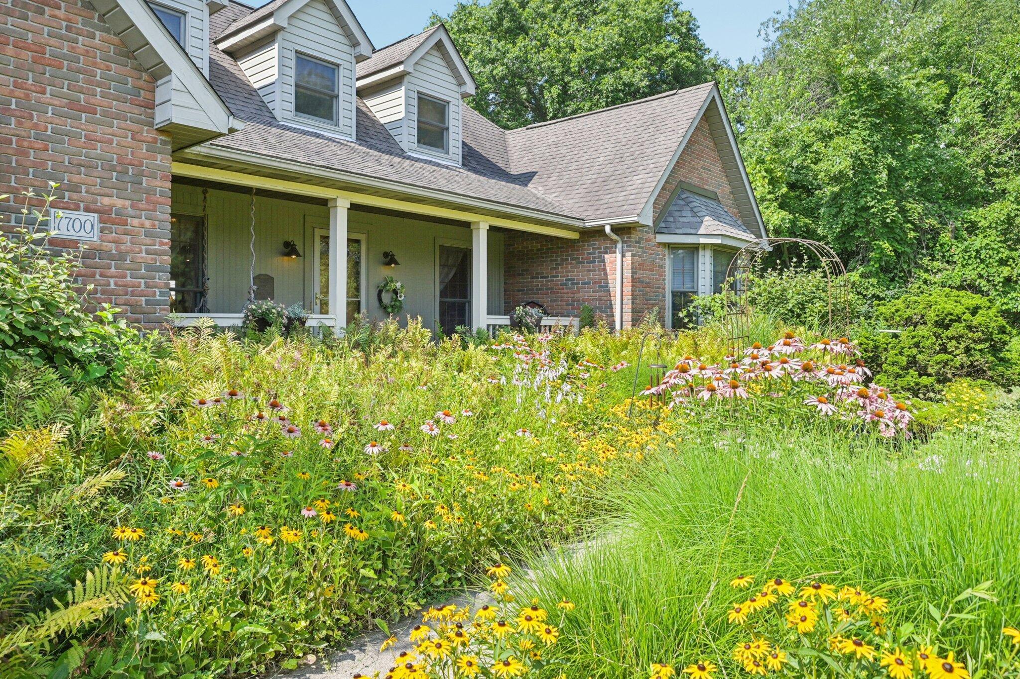 7700 Plumb Road Galena, OH 43021 - Photo 29 of 94 Colorful pollinator-friendly plantings line the front of the home, offering year-round curb appeal and a touch of country charm.