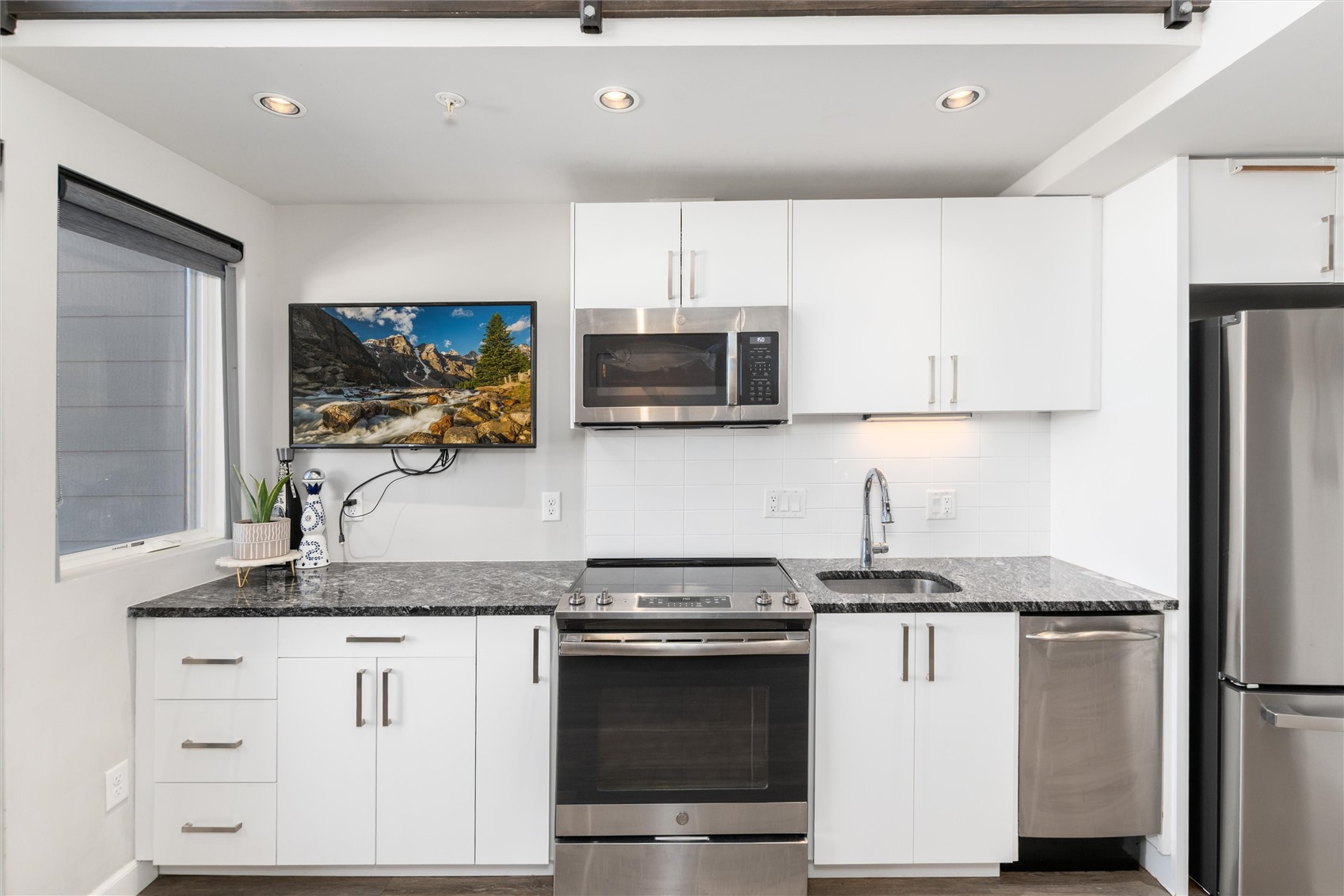100 Basecamp Way, Unit 215 Frisco, CO 80443 - Photo 11 of 26 Stone counters, stainless steel appliances, and customized soft-close cabinetry bring both function and contemporary style to the kitchen.