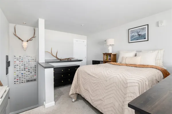 a bedroom with a bed and a lamp on the table