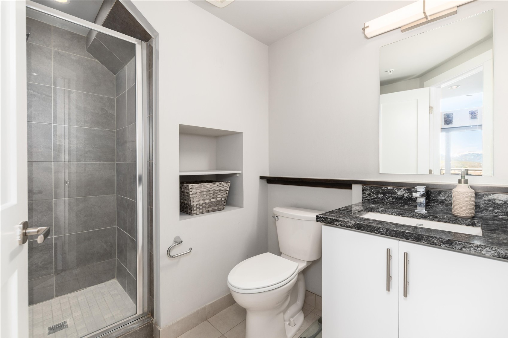 100 Basecamp Way, Unit 215 Frisco, CO 80443 - Photo 10 of 26 The full bath features luxurious modern tile and countertops.