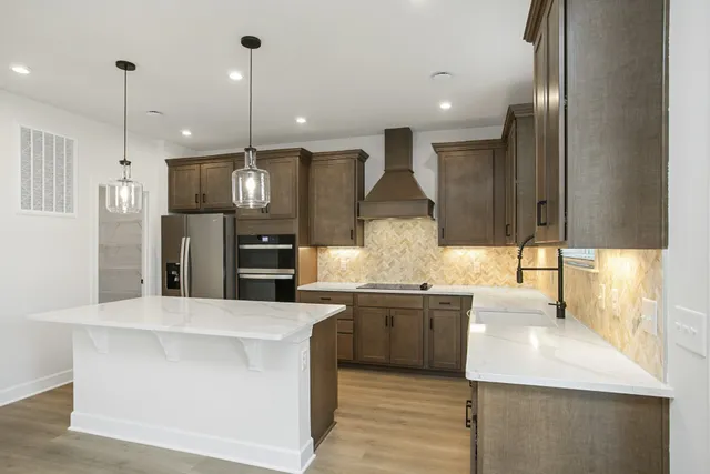 a large kitchen with stainless steel appliances kitchen island a large island in the center