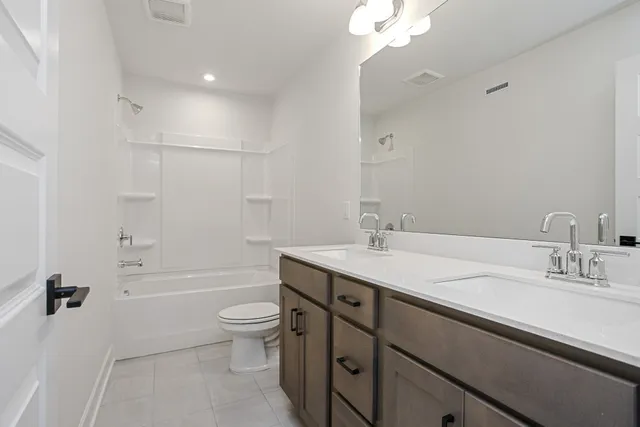 a bathroom with a granite countertop sink a toilet and shower