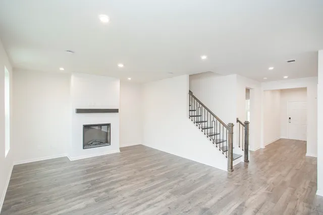 a view of entryway and hall with wooden floor