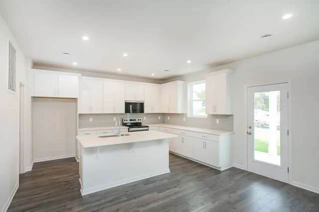 a kitchen with a stove a sink and a refrigerator